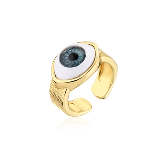 Macro detail of 18K gold-plated evil eye ring featuring blue iris and hammered metal texture