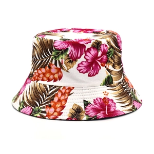 Reversible bucket hat with tropical floral print featuring hibiscus flowers and palm leaves