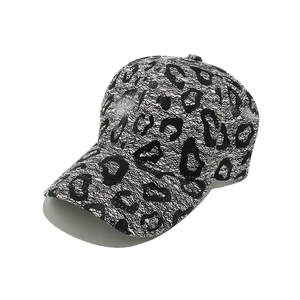 Close-up of black and white leopard print lace texture on stylish baseball cap detail