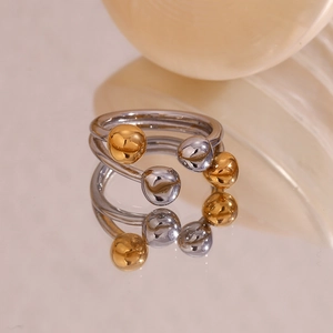Detail of creative two-tone 18K gold plated stainless steel open ring with spherical tips