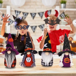 Set of four plush Halloween faceless gnome dolls with various hats on a wooden table