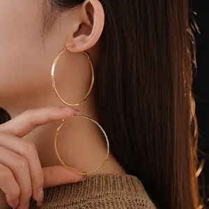 Gold plated large hoop earrings with hammered texture finish for a minimalist chic look