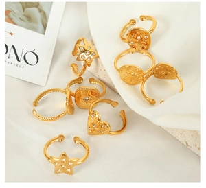 Macro shot of assorted geometric gold-plated adjustable rings with inlaid cubic zirconia