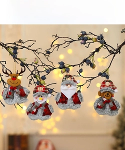 Close-up of fabric Christmas ornaments with elk, snowman, Santa, and bear characters