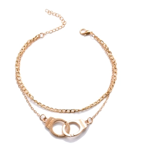 Golden double-layer anklet with freedom handcuff pendant on white background