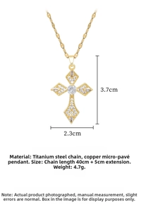 Macro detail of gold cross necklace with micro-pave white zircon and titanium chain