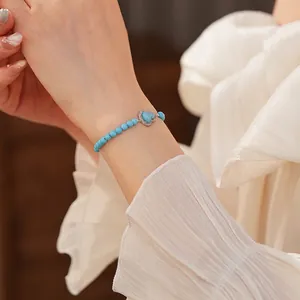 Elegant beaded bracelet with sky blue turquoise stones and a heart-shaped zircon pendant