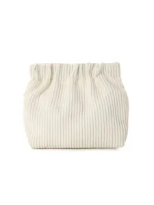 Close-up of cream corduroy storage pouch showing soft ribbed texture and elastic top