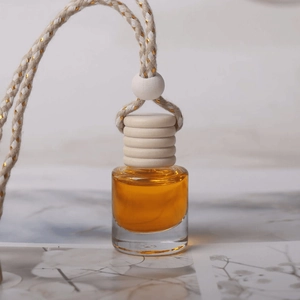 Hanging car perfume bottle with amber liquid, wooden cap and braided lanyard accessory