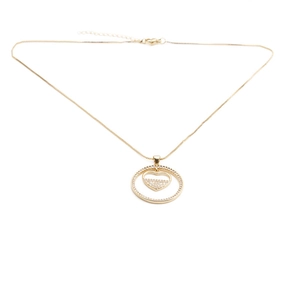 Macro detail of gold plated heart pendant necklace with shimmering zircon stones