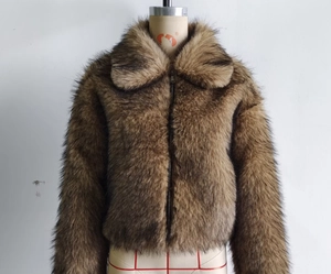 Close-up of brown faux fur jacket featuring zipper closure and cozy turnover collar