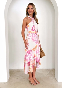 Détail de robe dos nu fleurie avec fleurs roses, lien à la taille et ourlet volanté