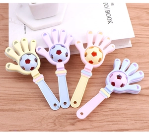 Detailed view of four colorful macaron football hand clappers for parties and sports