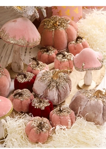 Detail of velvet pumpkins and glitter mushrooms for festive desktop decoration