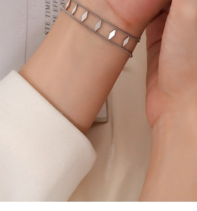 Silver double-layer geometric rhombus chain bracelet shown on a female wrist