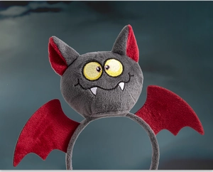 Detail of Halloween bat headband with plush grey texture and burgundy embroidered wings