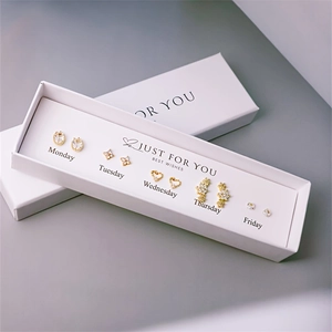 Detailed set of five pairs of gold-tone pearl earrings in a white gift box for daily wear