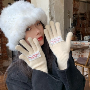 Detailed embroidery of French text on beige knitted winter gloves for women