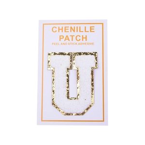 Detail of chenille letter U patch with gold glitter edge and peel and stick adhesive backing