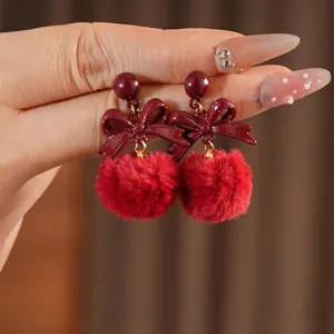 Bowknot plush pompom earrings with silver needles and dark red velvet finish for women