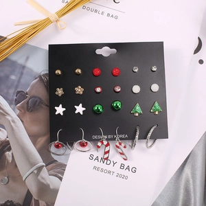 Detailed close-up of a Christmas earring set featuring festive stars, trees, and candy canes