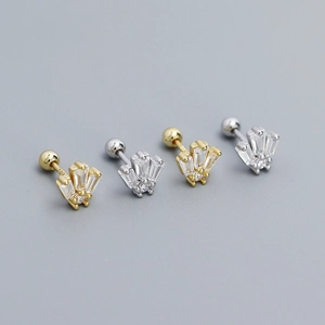 Macro shot of silver and gold piercing studs with T-square cut cubic zirconia gems