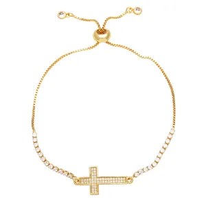 Adjustable gold-plated cross bracelet with cubic zirconia and a slide bead closure