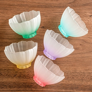 Gradient lotus glass tea cups set with frosted petal design on dark wood background