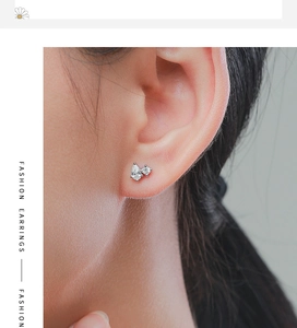 Detailed close-up of a pear-shaped cubic zirconia and round diamond stud in S925 silver