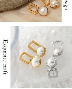 Detail view of geometric square pearl drop earrings in gold and silver finish options