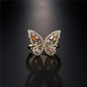 Golden butterfly ring with multi-color zircon stones and white crystals in an open design