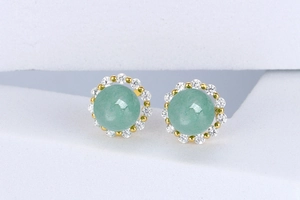 Detail of round green aventurine stud earrings with pavé crystal halo and gold finish