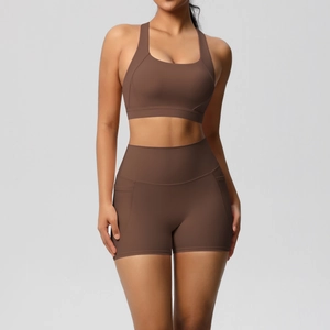 Detail of high-waist yoga shorts with side pockets in chocolate brown matte fabric