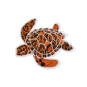 Orange and black embroidered sea turtle patch with detailed animal spot pattern