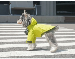 Detail view of pet raincoat with adjustable velcro straps and neon waterproof coating