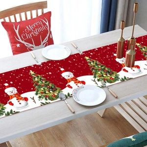 Festive red Christmas table runner featuring snowmen and trees for holiday dining decor