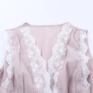 Close-up of V-neckline with delicate white lace trim on dusty pink chiffon tank top