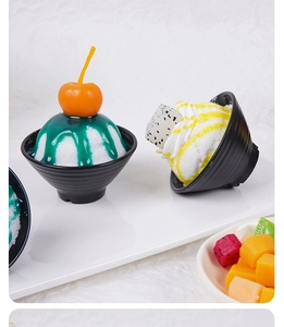 Close-up of artificial fruit shaved ice bowl models with syrup and pitaya slices