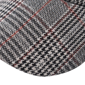 Macro shot of high-quality woven plaid fabric detailing on a classic baseball cap brim