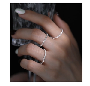 Close-up of minimalist S925 sterling silver cauliflower chain ring with sparkling texture