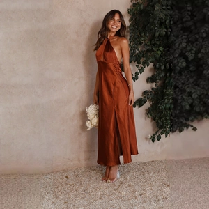 Detail of satin halter neck dress featuring crisscross back and high side slit design