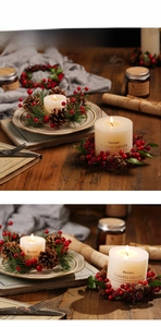 Close-up of a Christmas candle with a red berry and pine cone wreath on a wooden table