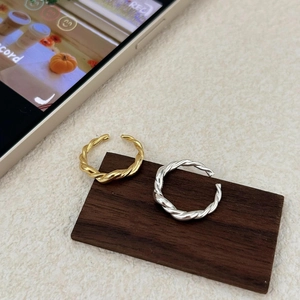 Minimalist 925 sterling silver twisted open rings in gold and silver finish on wood