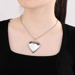 Polished silver heart pendant necklace on snake chain, minimalist metal jewelry for women