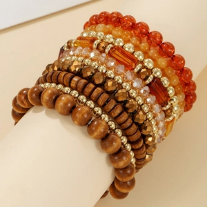 Detail of bohemian multilayer bracelet set with brown wood beads and amber crystals