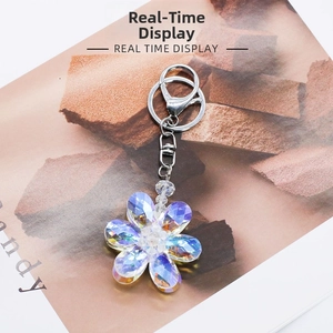 Close-up of crystal flower keychain with silver lobster clasp and iridescent petals