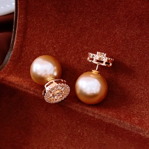Detail view of luxury 14k gold plated stud earrings with champagne pearls and zircons