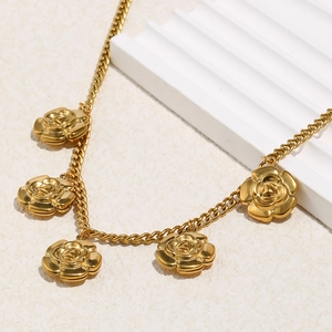 Detailed close-up of 18K gold plated stainless steel necklace with five 3D rose charms