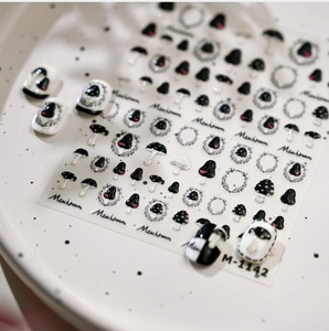 Detail of M-1142 mushroom nail stickers with minimalist black and white patterns