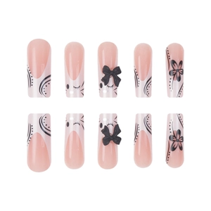 Pink ballet style press-on nails with 3D black bows and cat-eye artistic patterns